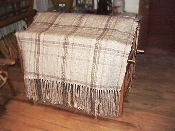 Image of the throw draped over one of the floor looms