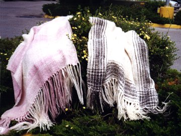 Two light weave throws on display